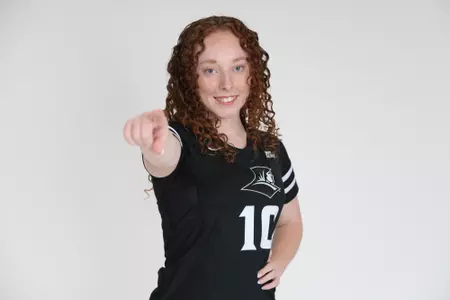 Morgan Martin is pictured posing by pointing at the camera with her right hand with her left hand placed at her hip during team photoshoot for pre-season 2025 photos.