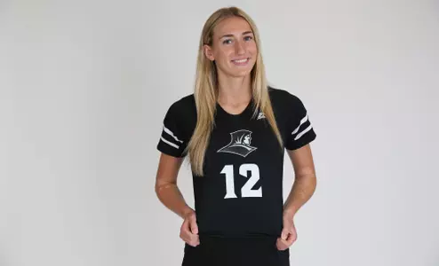 Fielding Mayhugh is pictured showing off her jersey and smiling at the camera during team photoshoot for pre-season 2025 photos.