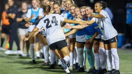 Women's soccer player Lily Gibbs high fives the bench after scoring a goal versus Army on August, 14 2025 at Chapey Field at Anderson Stadium