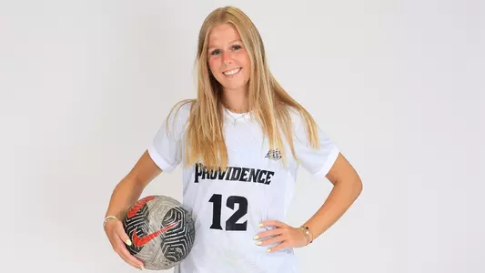 Women's soccer player Mara Batchen poses for a photo with a balls in her hand during a preseason photoshoot in 2025
