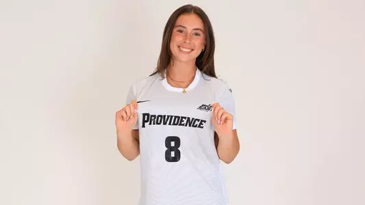 Women's soccer player Colleen Casey poses for a photo holding her jersey out during a preseason photoshoot in 2025