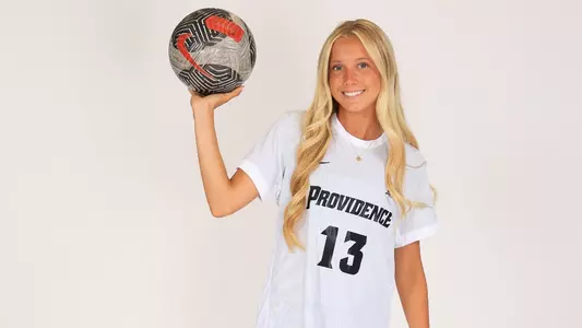 Women's soccer player Sophie Tonino poses for a photo with a ball in her hands during a preseason photoshoot in 2025