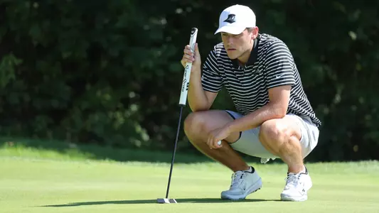 Men's golf player Kevin Legnard reading a putt