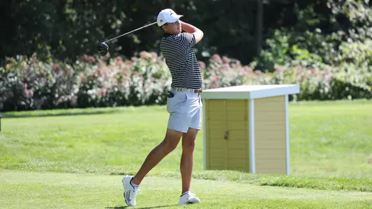 Men's golf player Campbell Skelly holding his follow through after a tee shot