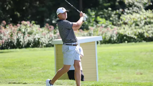 Men's golf player Evan Buddenhagen finishing his drive off the tee