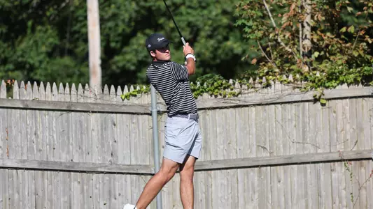 Men's golf player Callan Fahey holding his follow through after a tee shot