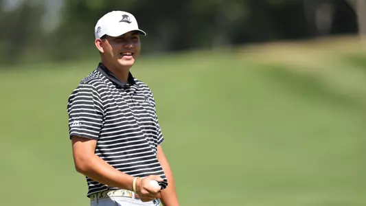 Men's golf player Campbell Skelly laughing on the golf course
