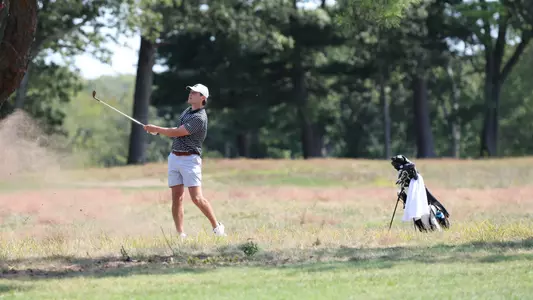 Men's golf player Kevin Legnard hitting an iron shot out of the rough
