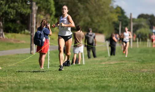 Cara Laverty about to cross the finish line at the Friar invitational on September 5th, 2025