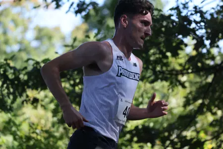 Side profile of Cormac Dixon running in a 2025 Cross Country meet.