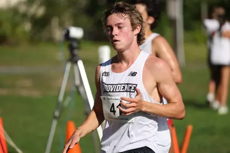 Jack Dowd crossing the finish line during a 2025 cross country meet.