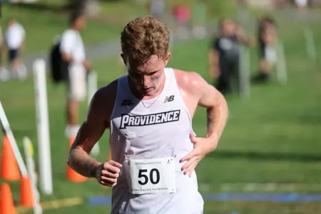 Ryan Welch crossing the finish line during a 2025 cross country meet