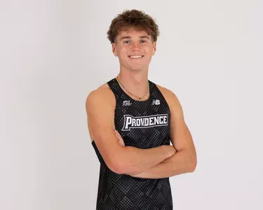Eli Wood looking at the camera with his arms crossed 