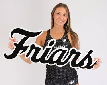 Britton Miller holding a Friars sign