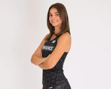Ava Russell crossing her arms and smiling at the camera