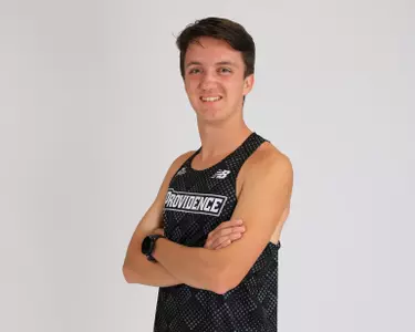 Adam Wedlake crossing his arms and smiling 