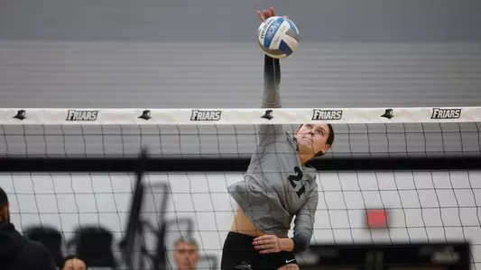Sophia Adkins hitting at Alumni Hall in Providence, R.I. against Merrimack
