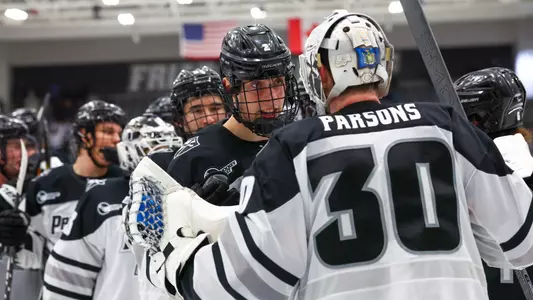 Men's Hockey's Jack Parsons celebrates with Tomas Machu after a win against Maine