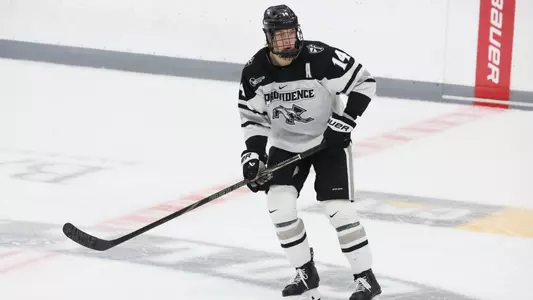 Men's hockey's Aleksi Kivioja skates in the neutral zone during a game at Schneider Arena