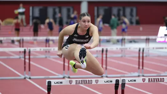 Women's track runner Ella Chandaria over hurdle
