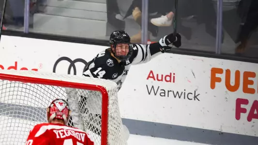 Men's hockey's Aleksi Kivioja celebrates a goal against Boston University