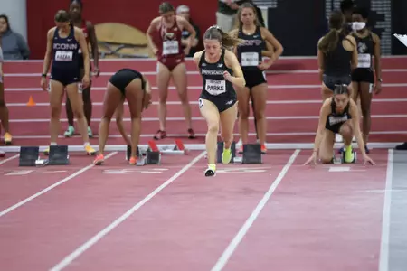 Cate Parks running on the track at the Harvard Beantown Challenge