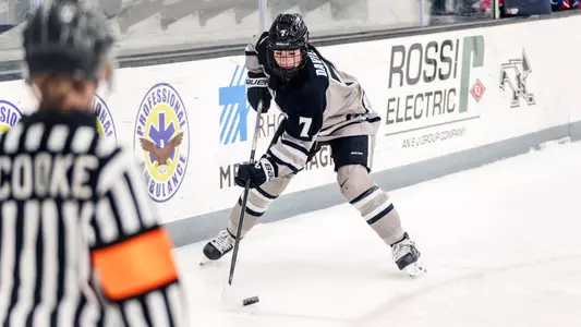 Women's ice hockey player Sarah Davies skating with the puck