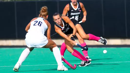 Ariana Ftorek shoots the ball by a defender 