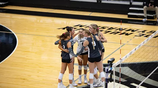 Volleyball vs DePaul team huddle after a point 