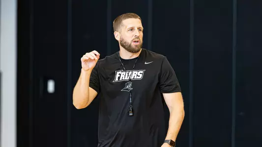 Men's basketball assistant coach Tee Butters coaching during practice