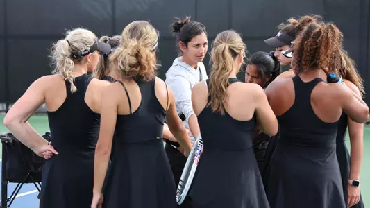 Women's Tennis team huddles before a match