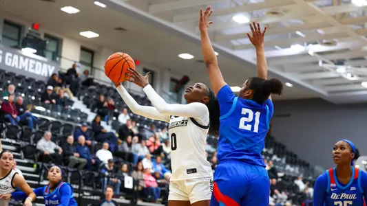 Sabou Gueye going up for a layup with a DePaul defender on her during a BIG EAST game at Alumni Hall in Providence, R.I.