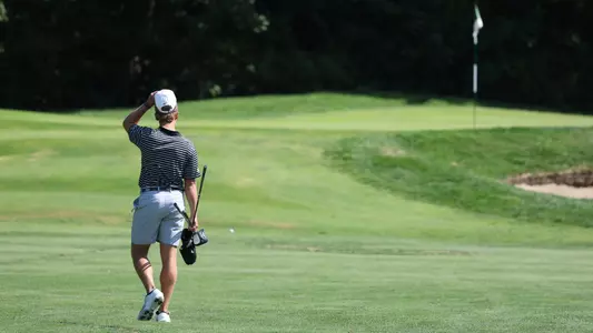 Men's golfer Evan Buddenhagen walking up the fairway