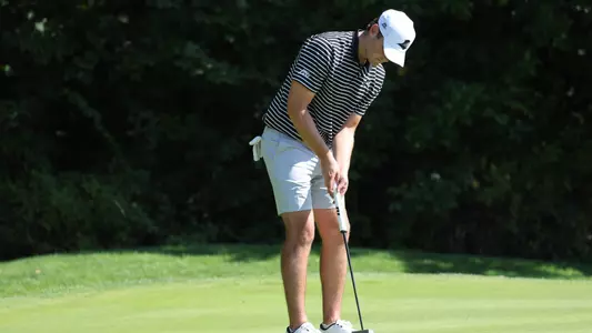 Men's golfer Kevin Legnard hitting a putt