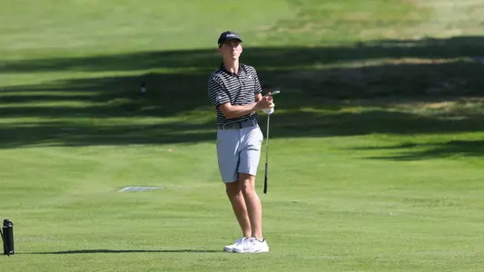 Men's golfer Liam O'Grady following througho on his chip shot