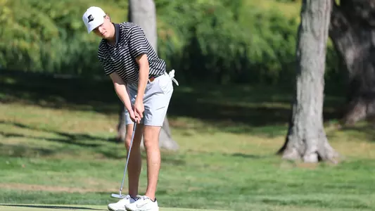 Men's golfer Will Spring hitting a putt