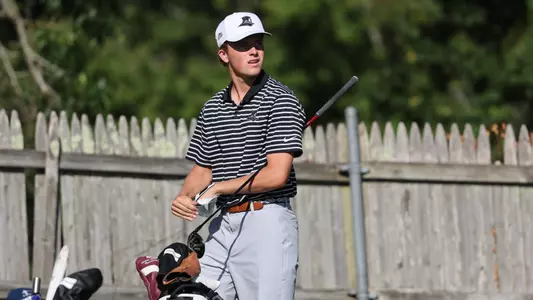 Men's golfer Will Spring taking his glove off after a tee shot