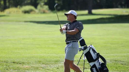 Men's golfer Evan Buddenhagen following through on a shot
