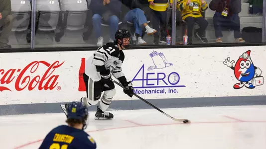 Men's Hockey's John Mustard in action against Merrimack