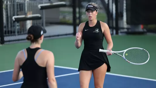 Women's Tennis' Allison Root celebrates in a match against Assumption