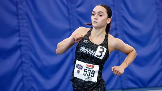 Elana running the relay at Big East Championships 