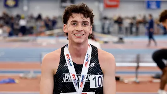 Elliott Pugh posing with silver medal at Big East Championships 