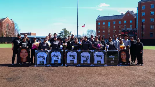 The seniors pose with their families for a photo on Softball Senior Day 2026
