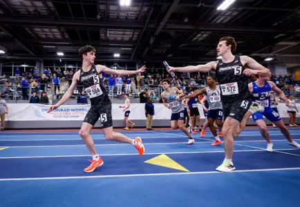 Matt McCabe receives the baton from Kyle Bloomer during the Distance Medley Relay at 2026 Big East Indoor Track Championships