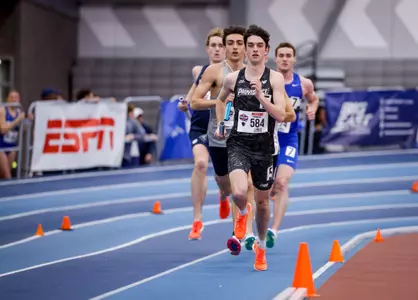 Matt McCabe runs with baton during relay at 2026 Big East Indoor Track Championships