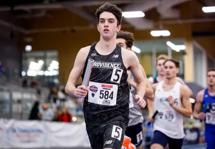 Matt McCabe runs with baton during Distance Medley Relay at 2026 Big East Indoor Track Championships
