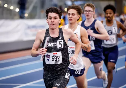 Elliott Pugh running with baton during relay at the 2026 Big East Indoor Track Championships