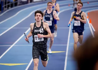 Elliott Pugh running with baton during relay at the 2026 Big East Indoor Track Championships