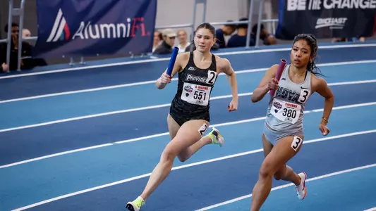 Chloe Higgins running with a baton in hand in the relay at 2026 Big East Indoor Track Championships