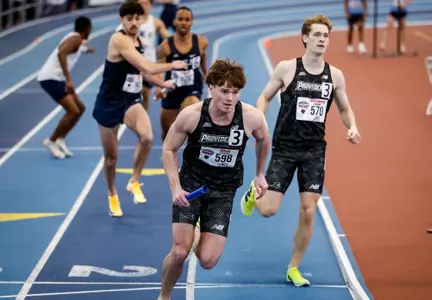 Eli Wood running after receiving the baton in the 4 by 400 meter relay at 2026 Big East Indoor Track Championships
